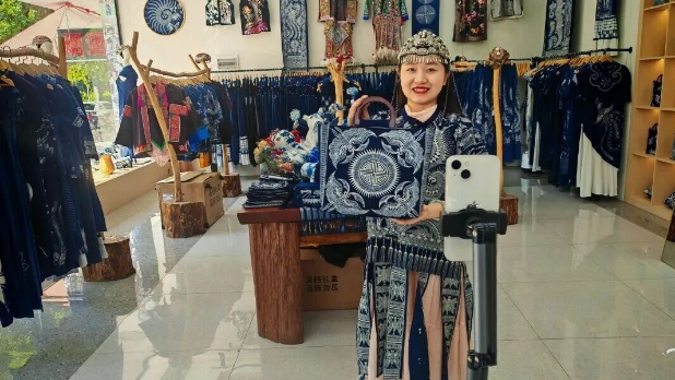 榕江县乡村主播刘勤兰正在向直播间里的观众展现当地苗族蜡染制品（袁仁雄 摄）